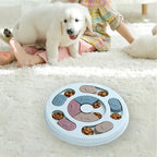 Puppy next to a round puzzle feeder